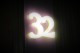 Illuminated numbers above the door