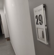 door number with a hole for the bell