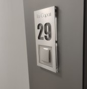 door number with a hole for the bell